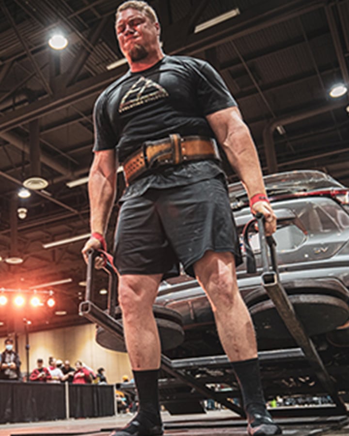 Strong man lifting car at Legion kids entertainment